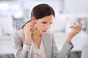 Call center agent helping a client via phone call to give them good customer service and care. Professional consultant employee at contact support listening to a person via her headset at work desk