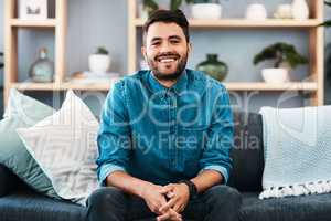 Nothing beats a couch day...well for me at least. Cropped portrait of a handsome young man smiling while sitting on a couch in his living room at home.