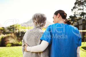 The scenery will cheer you up. a young female nurse outside with a senior patient.