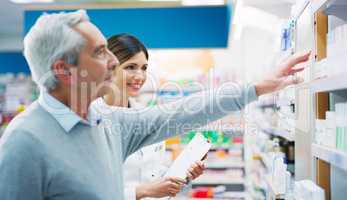 Im here to help my customers make wise decisions. a pharmacist assisting a customer in a chemist.