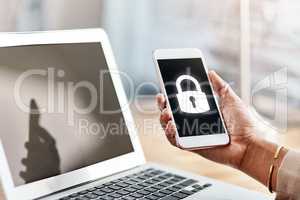 Locked out of any connection. an unrecognizable businesswoman using a cellphone and laptop in her office.