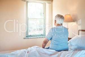 Life in a retirement home. an unrecognizable senior man sitting alone on the edge of his bed in a nursing home.