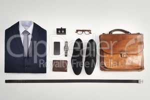 Flatlay of business suit, corporate formal attire with fashion accessories on a white table background. Still life above view of modern clothing style with phone for a professional and neat lifestyle