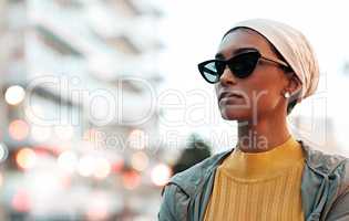 Feeling chic and confident. an attractive young woman wearing a hijab and sunglasses while touring the city.