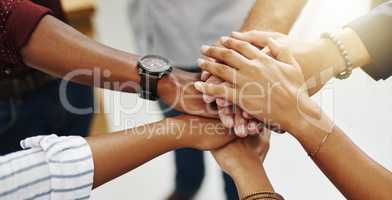 Diverse people stacking or piling hands in teamwork, success and support to show solidarity, trust and unity in office. Closeup of business team, men and women standing together and feeling motivated