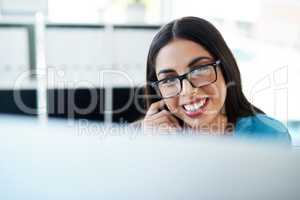 Pursuing some of her biggest entrepreneurial dreams. Portrait of a young businesswoman working on a computer in an office.