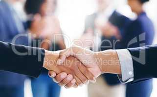 Grab profitable deals with both hands. a businessman and businesswoman shaking hands in a modern office.