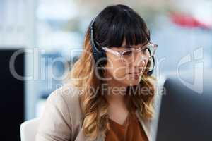 Let me look for that information for you. an attractive young businesswoman sitting and using a headset in her office during the day.