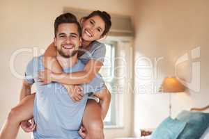 Live a life full of love and happiness. Portrait of a playful young couple spending some quality time together in their bedroom.