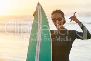 Days spent at the beach are always the best. Portrait of a beautiful young female surfer posing with her surfboard at the beach.