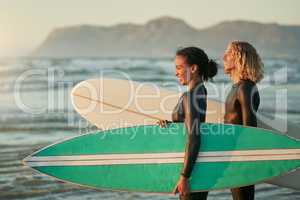 Were living a life full of adventure. a cheerful young couple going surfing at the beach.