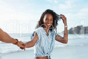 Im so ready for some summer fun. POV shot of a young woman holding her boyfriends hand at the beach.