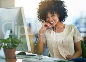 Successful, happy and confident business woman sitting at computer at desk with a positive mindset. Beautiful, healthy female entrepreneur or innovative, trustworthy leader smiling while working.