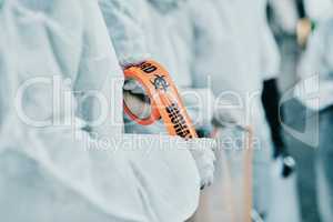 Covid healthcare workers responding to a biohazard in a public area using barrier tape. First responders in protection hazmat suits cordoning a space due to a new pandemic or outbreak