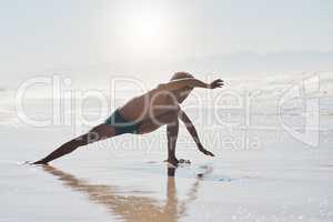 Dance isnt just dance, its something that sets you free. Full length shot of a handsome young man performing a challenging dance sequence on the beach during the day.