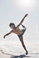 Dancing is just discovery. Full length shot of a handsome young man performing a challenging dance sequence on the beach during the day.