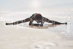 I use dance to cope with the challenges of life. Full length shot of a handsome young man performing a side split while dancing on the beach during the day.