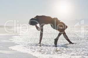 Dancers are the athletes of God. Full length shot of a handsome young man performing a challenging dance sequence on the beach during the day.