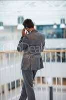 Some decisions with be your biggest letdown. Rearview shot of a young businessman looking stressed out while standing in an office.