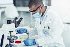 Medical, healthcare and science professional testing monkeypox, ebola or marburg virus under microscope in medical research. Biologist, scientist or pathologist examining DNA chemical reaction in lab
