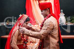 Their garlands represent a love thats true and passionate. a young hindu couple on their wedding day.