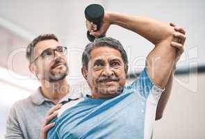 Hes getting stronger by the day. a senior man exercising with dumbbells during a rehabilitation session with his physiotherapist.