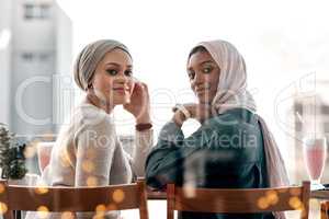 Spending time with your bestie is very important. Cropped portrait of two affectionate young girlfriends hanging out together at a milkshake cafe while dressed in hijab.