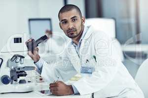 Vision, discovery and thinking scientist leading with innovation and modern science in lab. Portrait of young biologist analyzing medical sample with microscope, on mission for cancer or corona cure