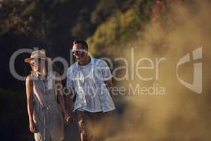 Long walks is what were all about. an affectionate mature couple taking a walk outdoors.