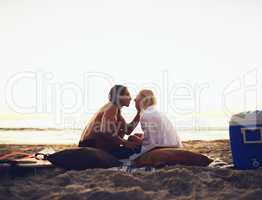 Can we just stay in this moment. a young affectionate couple sharing a tender moment during a date on the beach at sunset.