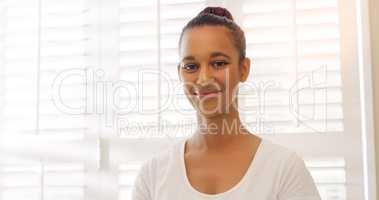 Her smile just calms everything down. Portrait of a beautiful young masseuse at a beauty spa.