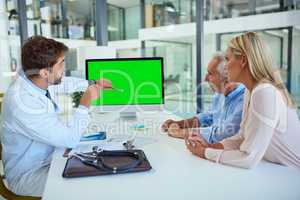 We need to start treating this as soon as possible. a doctor discussing findings on his computer with a senior man and his daughter at the clinic.