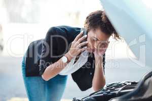 I need someone over here immediately. an attractive young businesswoman calling roadside assistance after her car broke down.