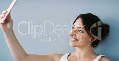 The worlds gotta see that smile. an attractive young woman posing for a selfie in her bedroom at home.