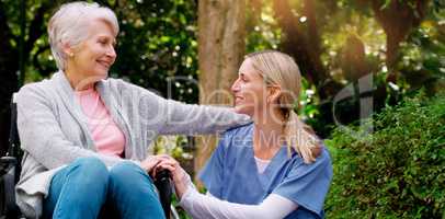 I am grateful to have you. a cheerful elderly woman in a wheelchair spending time with her daughter outside in a park.