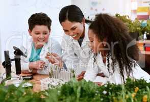 Knowledge grows when you nurture it. an adorable little boy and girl learning about plants with their teacher at school.