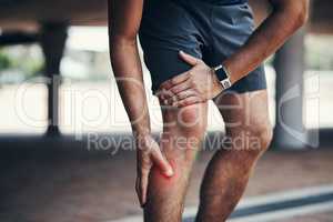 I first need to deal with this injury before I continue. Closeup shot of an unrecognizable man holding his leg in pain while exercising outdoors.