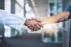 Lets go save some lives. Closeup shot of two medical practitioners shaking hands.