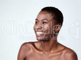 Shes got that sought after radiant skin. Studio shot of a beautiful young woman looking thoughtful against a grey background.