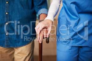 If you reach out, Ill be there to give a hand. a young nurse assisting a senior man whos walking with a cane.