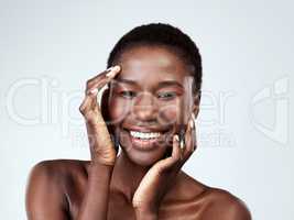 This is what perfection feels like. Studio portrait of a beautiful young woman feeling her skin against a grey background.