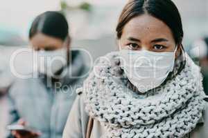 Sick young covid patient, wearing medical face mask to stop the spread of virus pandemic. Woman standing outside in public crowd during viral coronavirus outbreak. Female taking healthcare precaution