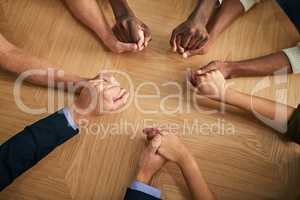 Diverse people holding hands in teamwork, success and support while showing solidarity, trust and office unity. Above view of business team, men and women standing together for equal workplace rights