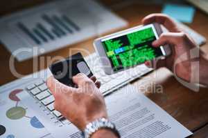 Cybersecurity issues or credit card theft by a hacker using his phone screen to write code. Closeup of the hands of man working on an interface programming for internet theft or unauthorized payment