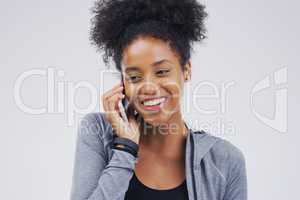 Dont hangup on happiness. Studio shot of a young woman using a mobile phone against a grey background.