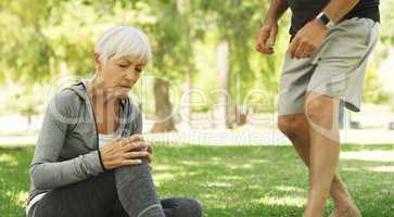 Hell always come to her rescue. a senior woman suffering a knee injury while out for a workout with her husband.