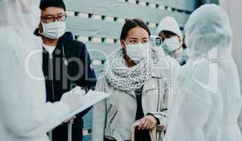 Traveling woman getting a covid temperature scan at the border with medical security doing screening test for safety during pandemic. Foreign people or traveler arriving at an airport with face mask