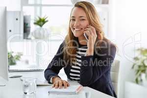 Handling all customer relations today. Portrait of an attractive businesswoman taking a phone call on at her office desk.