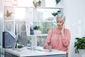 Always pay attention to detail when dealing with customers. mature businesswoman taking a phone call at her office desk at work.
