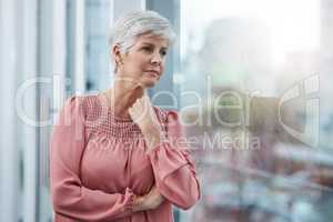 This issue has been stuck in my head the whole day. a mature businesswoman looking thoughtful in her office at work.